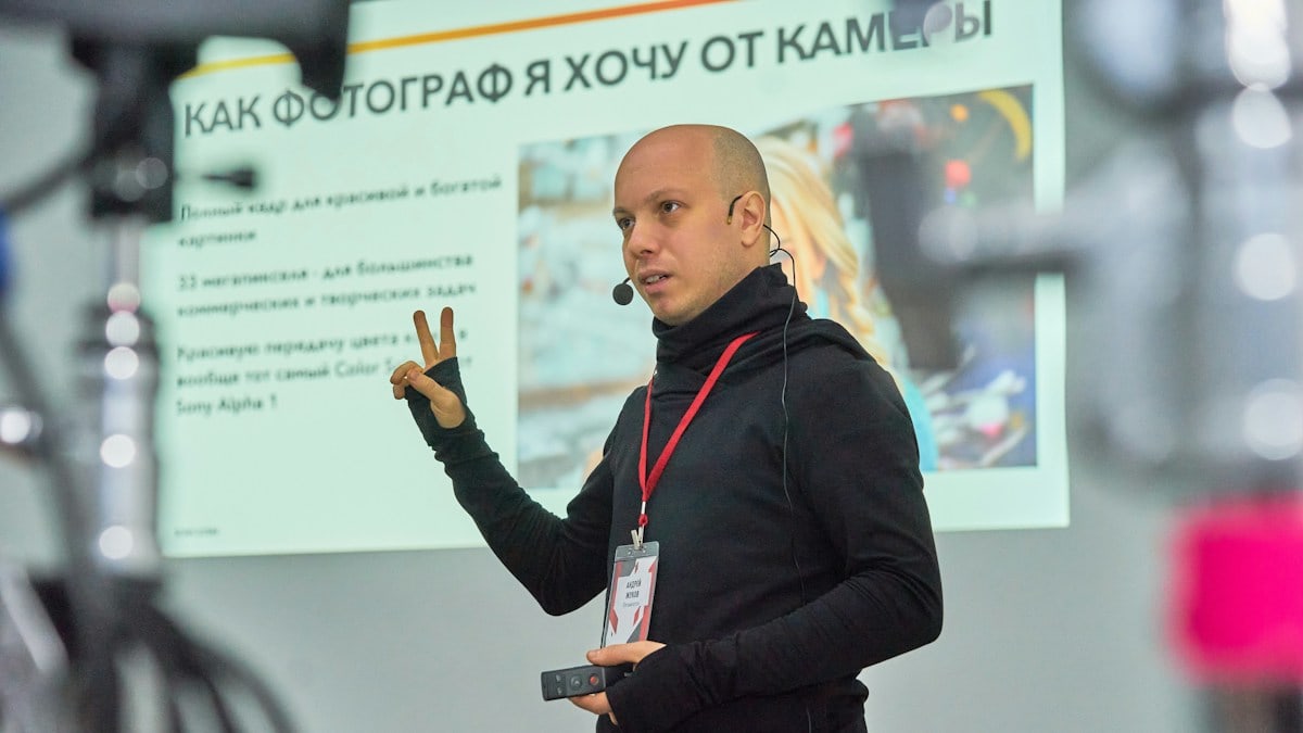 A man standing in front of a projector screen